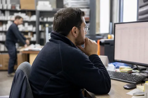 Retail analyst checking a long product export on a monitor