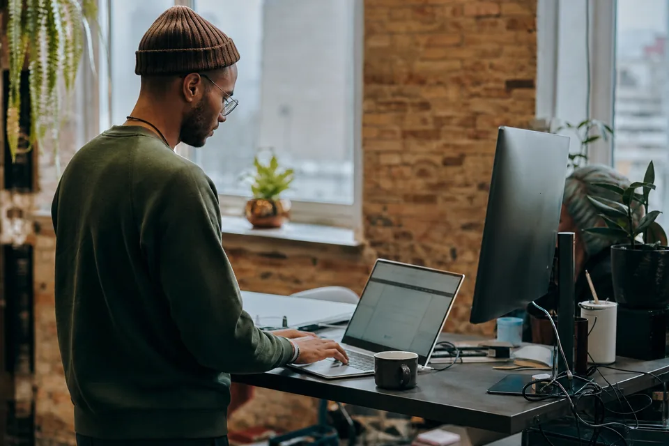 Integration engineer at a standing desk in a loft office